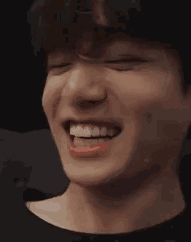 a close up of a person 's face with their mouth open and their eyes closed .