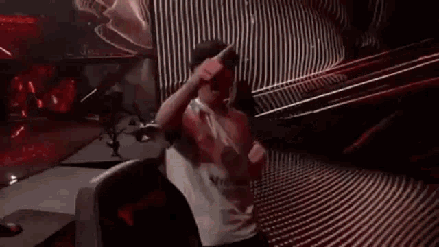 a man is sitting in a chair with his arms in the air and dancing .