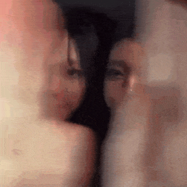 a blurry picture of a man and woman kissing