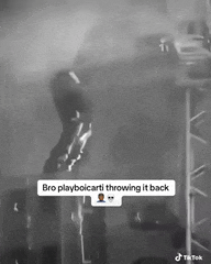 a black and white photo of a person throwing something back