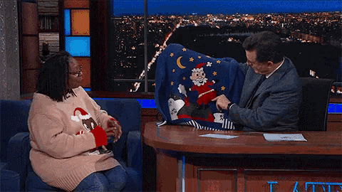 a person wearing a christmas sweater with a santa claus on it