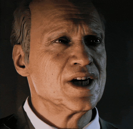 a close up of a man 's face in a suit