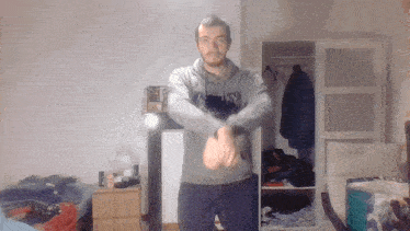 a man wearing a grey sweatshirt that says ' sns ' on it