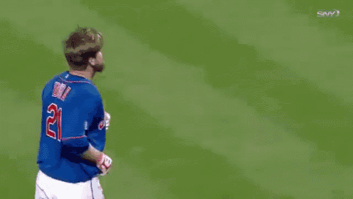 a man wearing a mets jersey is being high fived by his teammates