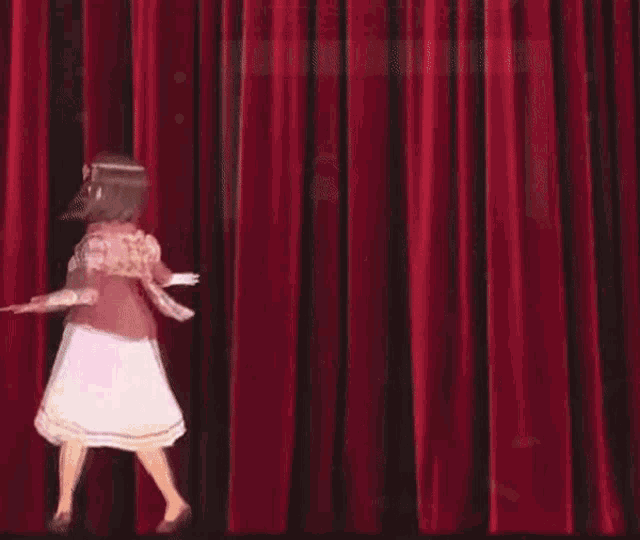a girl in a plaid dress is dancing on a stage