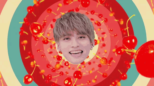 a man 's face is surrounded by cherries in a circular pattern