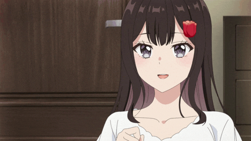 a girl with a red rose in her hair looks at the camera