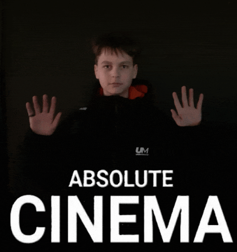 a boy in a black jacket stands in front of a sign that says absolute cinema