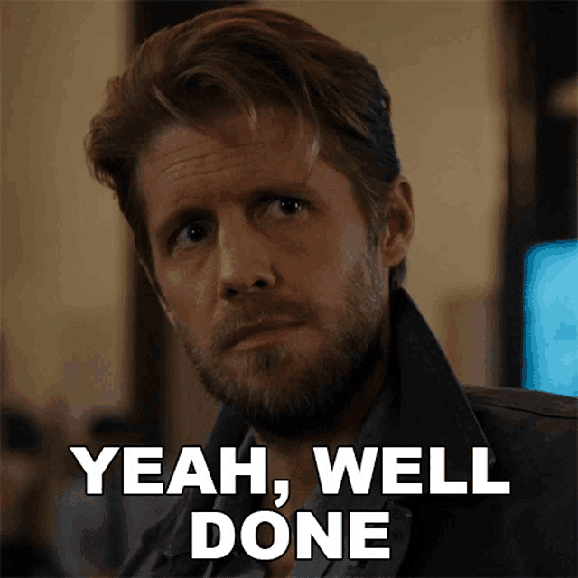 a man with a beard says " yeah well done " in front of his face