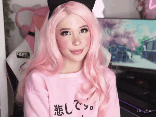 a girl with pink hair is wearing a sweater that says onlyfans on it