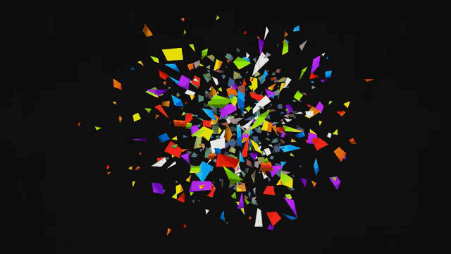 a bunch of colorful pieces of paper are flying in the air
