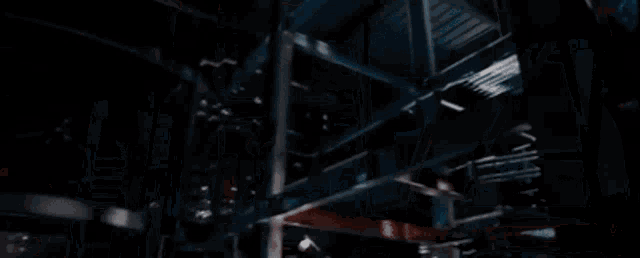 a man in a spiderman suit is laying on the ground .