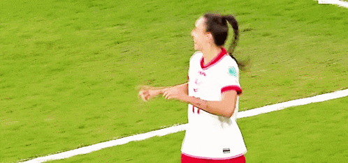 two female soccer players are hugging each other and one has the number 6 on her jersey