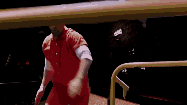 a man in a red prison uniform is standing in a dark room