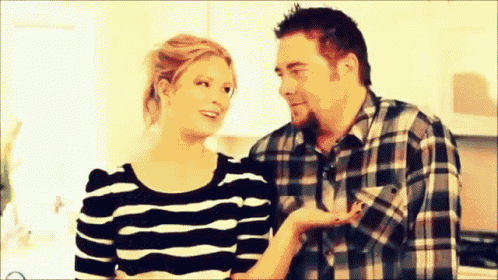 a man and a woman are standing next to each other