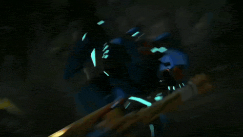 a blurred image of a cartoon character with a yellow and orange flower in the background