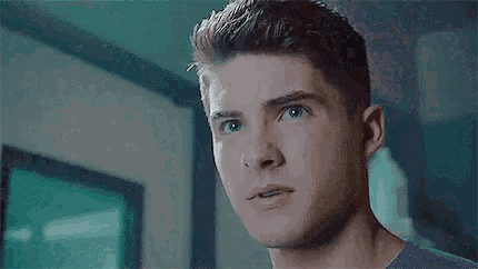 a close up of a young man 's face in a room .