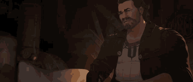 a man with a beard is holding a bottle in his hand