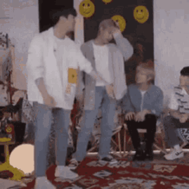 a group of young men are standing next to each other in a living room .