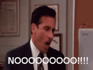 a man in a suit and tie is making a surprised face and saying nooo .
