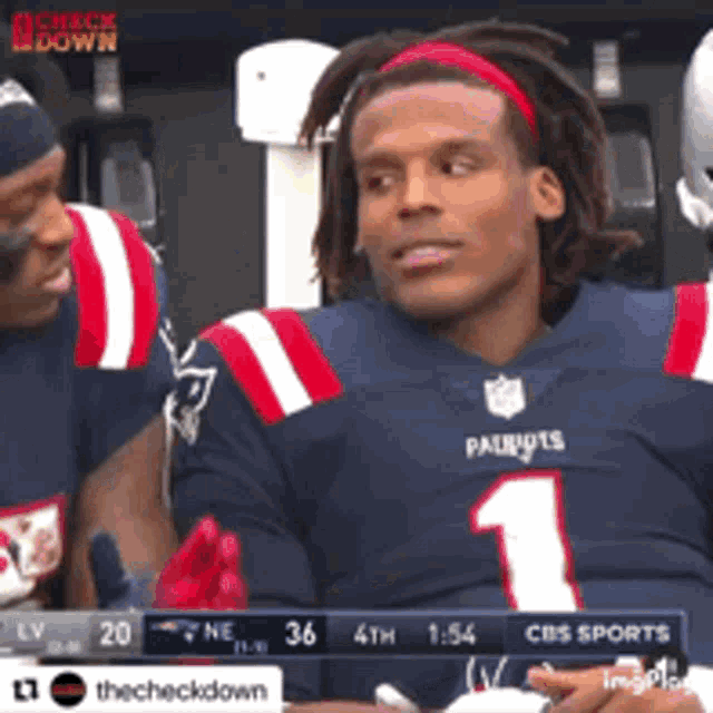 a patriots football player is sitting in the stands
