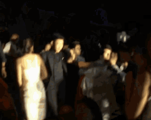 a blurry picture of a woman in a white dress
