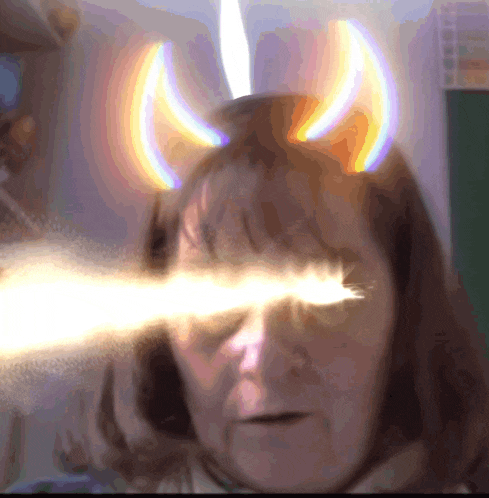a woman with horns on her head has a light coming out of her eye