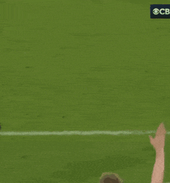 a soccer player wearing a yellow shirt that says etihad