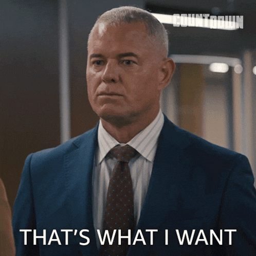 a man in a suit and tie has the words that 's what i want on his face