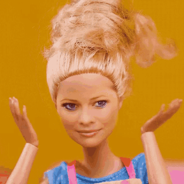 a barbie doll with blonde hair and blue eyes has her hands on her face