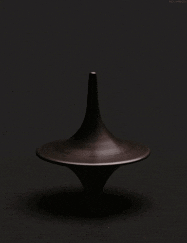 a black spinning top against a black background with the url http://www.flickr.com