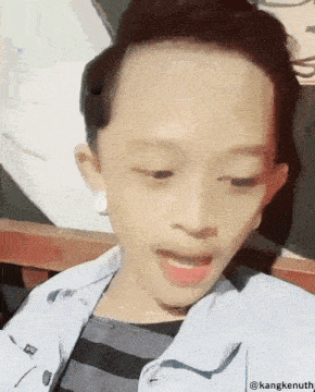 a young man is taking a selfie with the name kangkenuth on the bottom