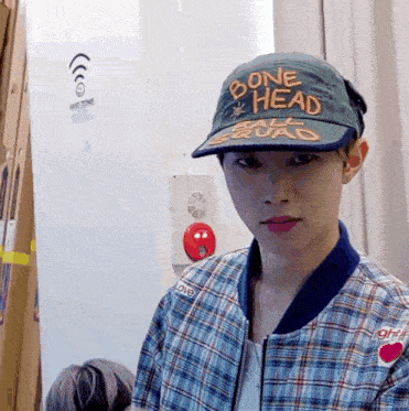 a young man wearing a hat that says bone head