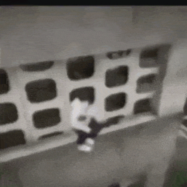 a person is jumping off a balcony into the air .