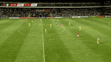 a soccer game is being played in a stadium with a score of 0-2