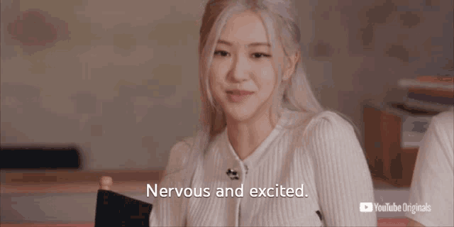 a woman is sitting in a chair with the words nervous and excited on the screen