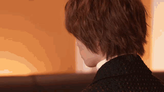 a close up of a person 's back with a polka dot jacket on
