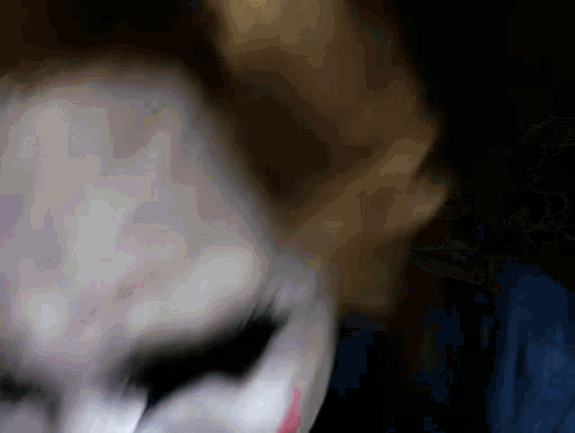 a close up of a woman 's face with a mask on
