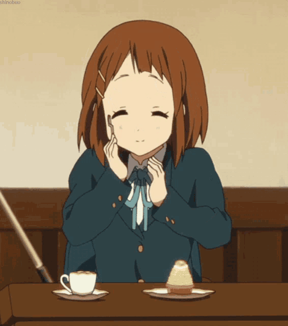 a girl sitting at a table with a cup of coffee