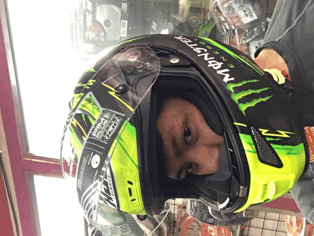 a man is wearing a helmet that says monster energy on it