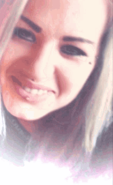 a close up of a woman 's face with a blurred background
