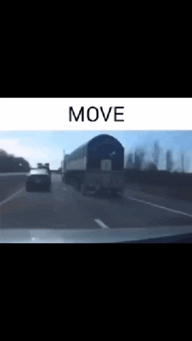 a car is driving down a highway next to a train that says move