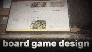a laptop is open to a page that says board game design on it