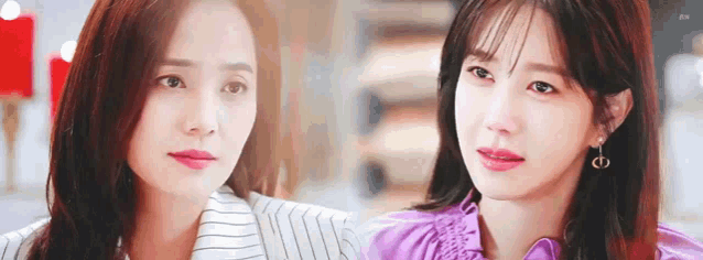 two women are standing next to each other in a room and looking at each other .