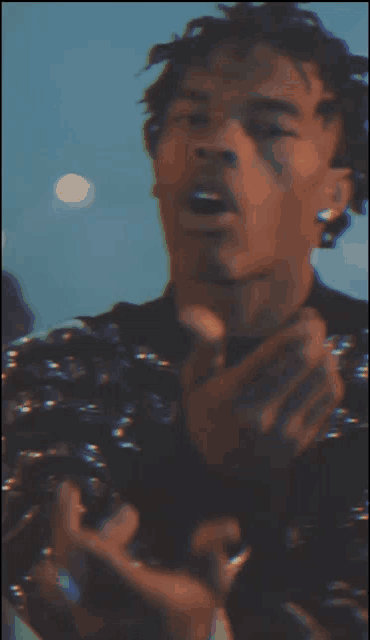a blurry picture of a man with a tattoo on his face .