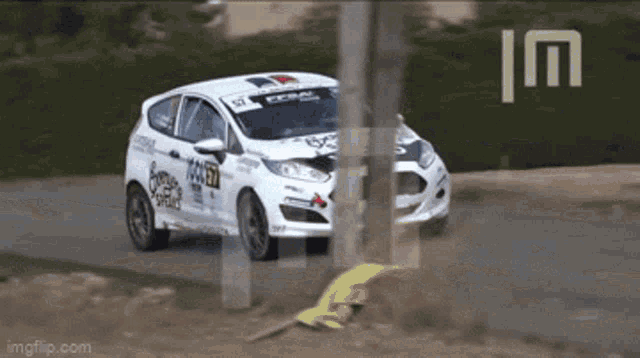 a white racing car with the number 57 on it