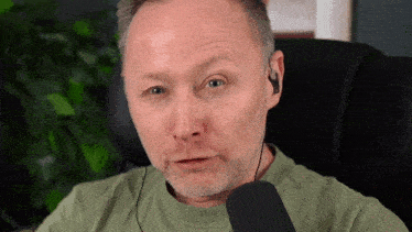a man with a beard is wearing ear buds