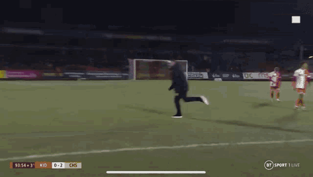 a man running on a soccer field with a score of 0 to 2