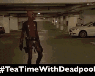 a man dressed as deadpool is walking in a parking garage .