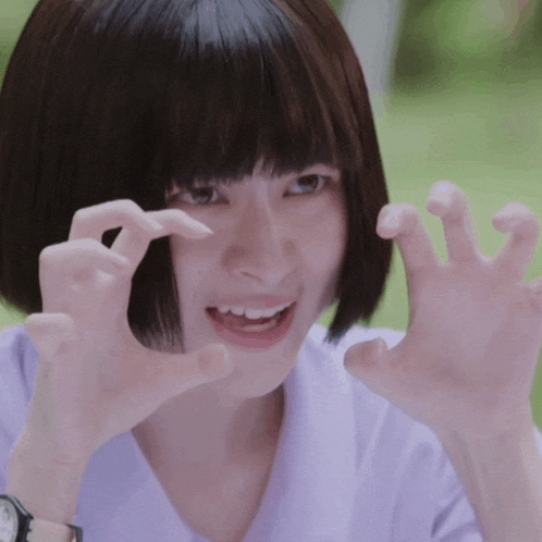 a girl making a funny face with her hands